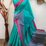 Rama green color raw silk saree with woven work