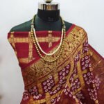 Maroon color hand bandhej silk saree with zari weaving work - Image 2